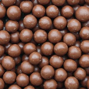 Organic milk chocolate coated hazelnuts